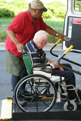 manhelpingwheelchaironlift.jpg